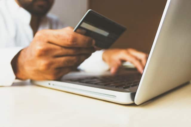 A person making an online payment on their laptop