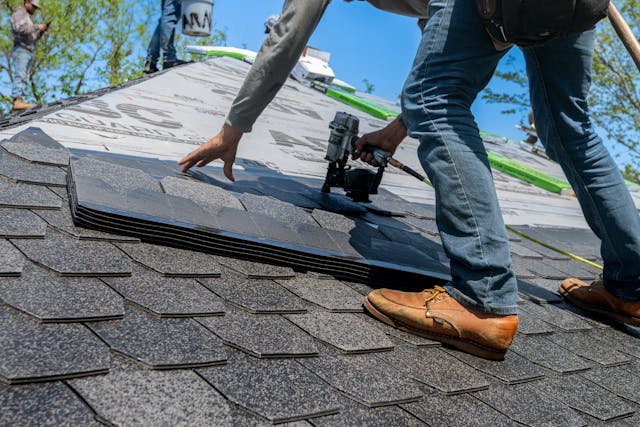 person repairing roof