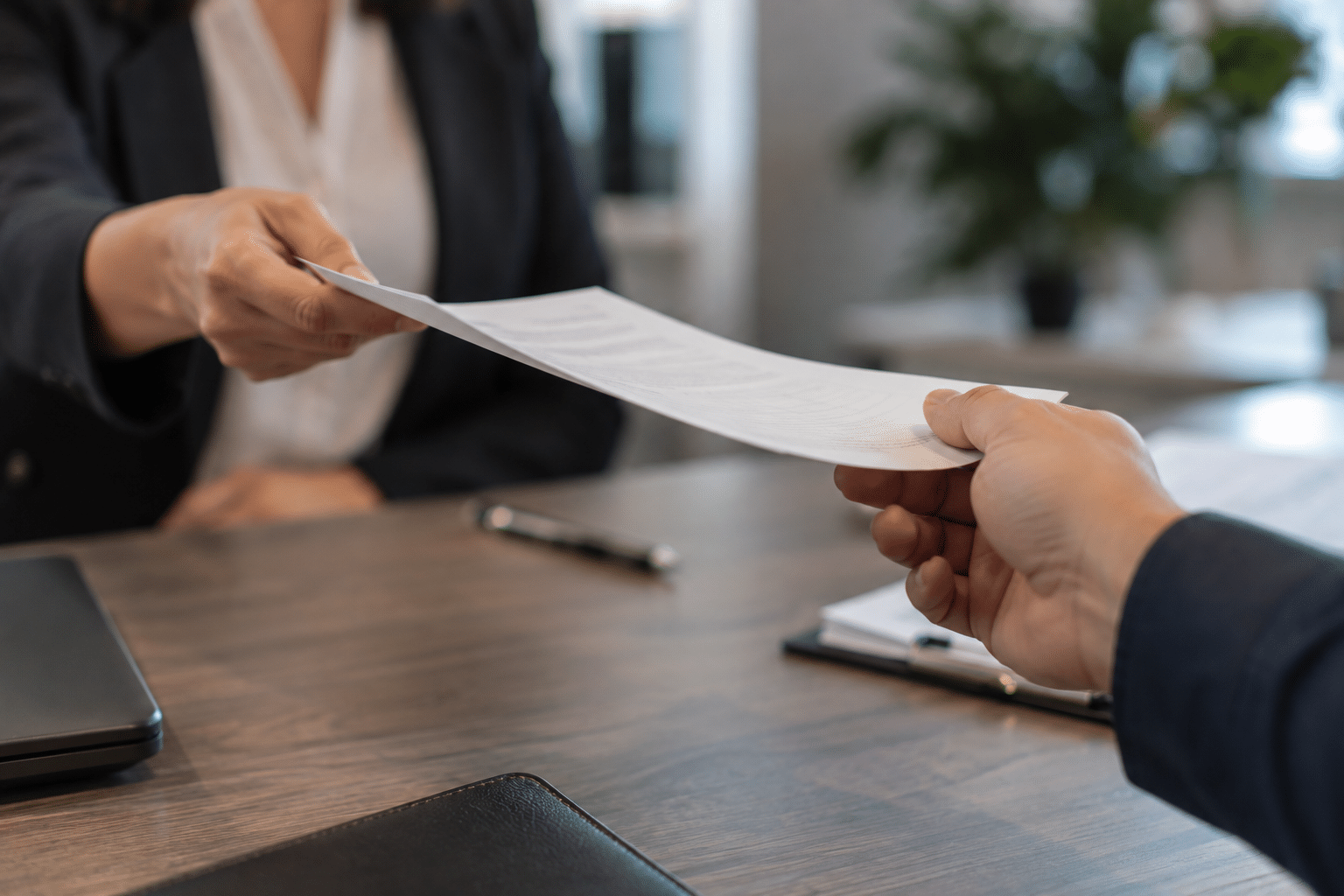 A person handing another person a document